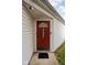 Inviting front door with wreath, security features, and sidelight, offering a warm welcome at 11620 Glenn Abbey Ln, Indianapolis, IN 46235