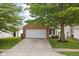 Charming single-Gathering home featuring a brick facade, a two-car garage, and mature trees enhancing curb appeal at 11620 Glenn Abbey Ln, Indianapolis, IN 46235