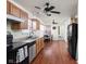 Functional kitchen with wooden cabinets, laminate counters, and black appliances, flowing into a dining area at 11620 Glenn Abbey Ln, Indianapolis, IN 46235