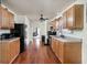 The spacious kitchen boasts ample cabinet storage, black appliances, and hardwood floors at 11620 Glenn Abbey Ln, Indianapolis, IN 46235