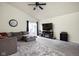 Comfortable living room with vaulted ceiling, plush carpeting, and sliding glass doors to the patio at 11620 Glenn Abbey Ln, Indianapolis, IN 46235
