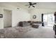 Comfortable living room with vaulted ceiling, plush carpeting, and sliding glass doors to the patio at 11620 Glenn Abbey Ln, Indianapolis, IN 46235