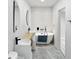 Elegant bathroom with a standalone tub, dual vanities, and modern fixtures at 1324 E 9Th, Indianapolis, IN 46202