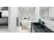 Modern bathroom with a soaking tub, sleek black fixtures, and stylish tiling at 1324 E 9Th, Indianapolis, IN 46202