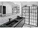 Modern bathroom with a double vanity, glass enclosed shower, and contemporary fixtures at 1324 E 9Th, Indianapolis, IN 46202