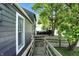 Home showcasing backyard accessibility via wooden ramp and mature shade trees at 1324 E 9Th, Indianapolis, IN 46202