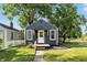 Charming single-story home with blue siding, white trim, landscaped yard, and a sidewalk leading to the front door at 1324 E 9Th, Indianapolis, IN 46202