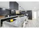 Modern kitchen with a large island, black cabinets, and stainless steel appliances at 1324 E 9Th, Indianapolis, IN 46202