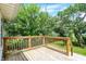 Enjoy outdoor living on the wooden back deck surrounded by lush trees and a grassy backyard at 1411 N Linwood Ave, Indianapolis, IN 46201