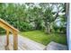 Outdoor living space featuring a wooden deck overlooking a well-maintained backyard with mature trees at 1411 N Linwood Ave, Indianapolis, IN 46201