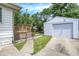 Exterior shot with a detached garage and wooden deck with a fenced yard, perfect for outdoor enjoyment at 1411 N Linwood Ave, Indianapolis, IN 46201