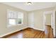 Bedroom featuring wood floors, neutral walls, and two windows at 1411 N Linwood Ave, Indianapolis, IN 46201