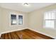 Cozy bedroom with refinished hardwood floors and natural light from the windows at 1411 N Linwood Ave, Indianapolis, IN 46201
