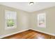 Bedroom featuring wood floors and two windows for natural light at 1411 N Linwood Ave, Indianapolis, IN 46201