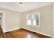 Bedroom with wood floors, neutral walls, and two windows at 1411 N Linwood Ave, Indianapolis, IN 46201