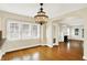 Bright dining room features hardwood floors, decorative chandelier, and large windows at 1411 N Linwood Ave, Indianapolis, IN 46201