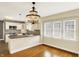 Dining area adjacent to the kitchen with a decorative chandelier and large windows at 1411 N Linwood Ave, Indianapolis, IN 46201
