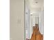 Hallway leading to rooms, featuring wood floors and neutral walls at 1411 N Linwood Ave, Indianapolis, IN 46201