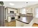 Kitchen features stainless steel appliances, stone backsplash, and modern lighting at 1411 N Linwood Ave, Indianapolis, IN 46201