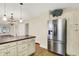 Kitchen with stainless steel refrigerator, custom cabinets, and views to the dining area at 1411 N Linwood Ave, Indianapolis, IN 46201