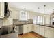 Kitchen features stainless steel appliances, custom cabinets, and granite countertops at 1411 N Linwood Ave, Indianapolis, IN 46201