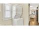 Laundry room featuring stackable washer and dryer and view into the Kitchen at 1411 N Linwood Ave, Indianapolis, IN 46201