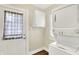 Laundry room with stackable washer and dryer and door to outside at 1411 N Linwood Ave, Indianapolis, IN 46201
