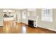 Spacious living room featuring hardwood floors, fireplace, and an open view into the adjacent kitchen at 1411 N Linwood Ave, Indianapolis, IN 46201
