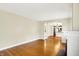 Open-concept living room with hardwood floors, fireplace, and a view into the adjacent kitchen area at 1411 N Linwood Ave, Indianapolis, IN 46201
