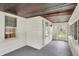 A sunroom with white walls and trim, multiple windows, a wood ceiling, and a gray floor at 1411 N Linwood Ave, Indianapolis, IN 46201