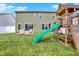 A spacious backyard features a playset with slide, perfect for outdoor enjoyment and Gathering fun at 1460 Boots Trl, Greenfield, IN 46140