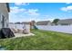This backyard is complete with a patio, grill, playset, and lush lawn, ideal for outdoor living at 1460 Boots Trl, Greenfield, IN 46140