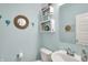 Bathroom with light blue walls, decor and a white sink and toilet at 1460 Boots Trl, Greenfield, IN 46140