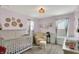 Bedroom room featuring wainscoting, a white crib, and neutral tones at 1460 Boots Trl, Greenfield, IN 46140