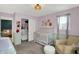 Bedroom room featuring wainscoting, a white crib, and neutral tones at 1460 Boots Trl, Greenfield, IN 46140