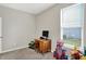 Bedroom with a gray carpet, a window, and a desk with a computer and ' toys at 1460 Boots Trl, Greenfield, IN 46140