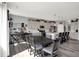 Bright dining area with a dark wood table, kitchen island, and decor on the sideboard at 1460 Boots Trl, Greenfield, IN 46140