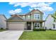 Charming two-story home featuring a well-manicured lawn and attached two-car garage, with a quaint front porch at 1460 Boots Trl, Greenfield, IN 46140