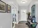 Inviting foyer with light gray walls and hardwood flooring, leading to a study with glass doors at 1460 Boots Trl, Greenfield, IN 46140