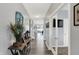 Inviting foyer with light gray walls and hardwood flooring, leading to a study with glass doors at 1460 Boots Trl, Greenfield, IN 46140