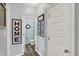 Hallway with light blue walls, white doors and decor with a view to the bathroom at 1460 Boots Trl, Greenfield, IN 46140