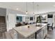 Bright kitchen featuring a large island with a marble countertop and stainless steel dishwasher at 1460 Boots Trl, Greenfield, IN 46140