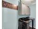 Laundry room with light blue walls, white cabinets and modern washer and dryer units at 1460 Boots Trl, Greenfield, IN 46140