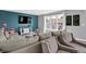 Stylish living room with hardwood flooring, comfortable seating, modern decor and large television at 1460 Boots Trl, Greenfield, IN 46140