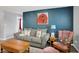 Comfortable living room with sofa, armchair, and natural light from nearby windows at 1460 Boots Trl, Greenfield, IN 46140