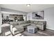 Open-concept living room featuring a large sectional sofa, modern decor, and seamless flow to the kitchen at 1460 Boots Trl, Greenfield, IN 46140