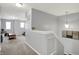 Open loft area with neutral carpet, pendant lighting, and ample natural light at 1460 Boots Trl, Greenfield, IN 46140