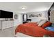 Large main bedroom with desk, and windows providing views of the backyard at 1460 Boots Trl, Greenfield, IN 46140