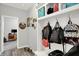 Mudroom featuring built-in storage, hooks, and a view into a bedroom at 1460 Boots Trl, Greenfield, IN 46140