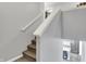 Carpeted staircase with white handrail leading to the second floor at 1460 Boots Trl, Greenfield, IN 46140